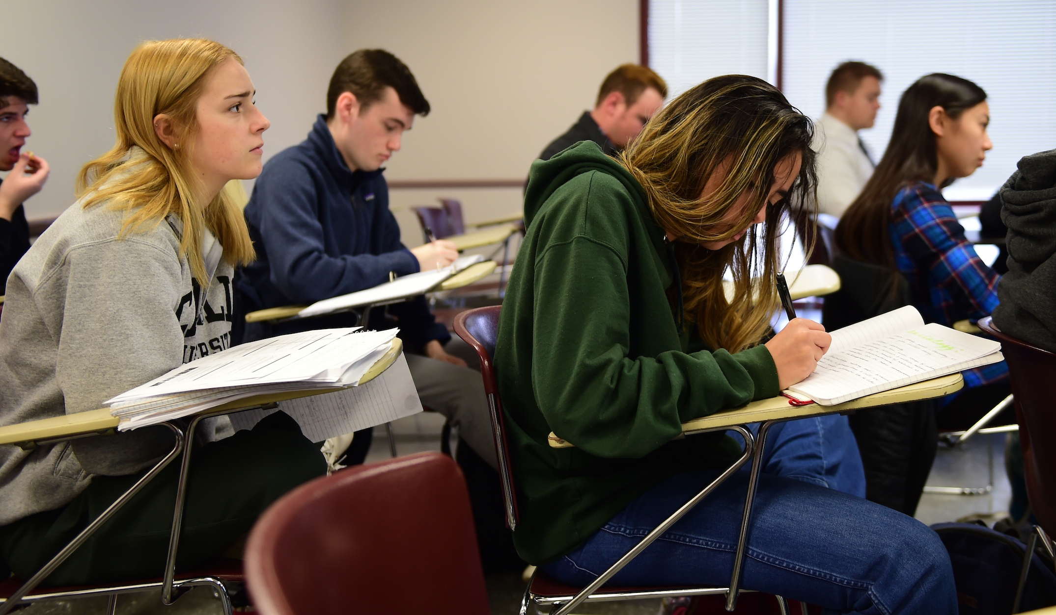 Students in a classroom taking notes